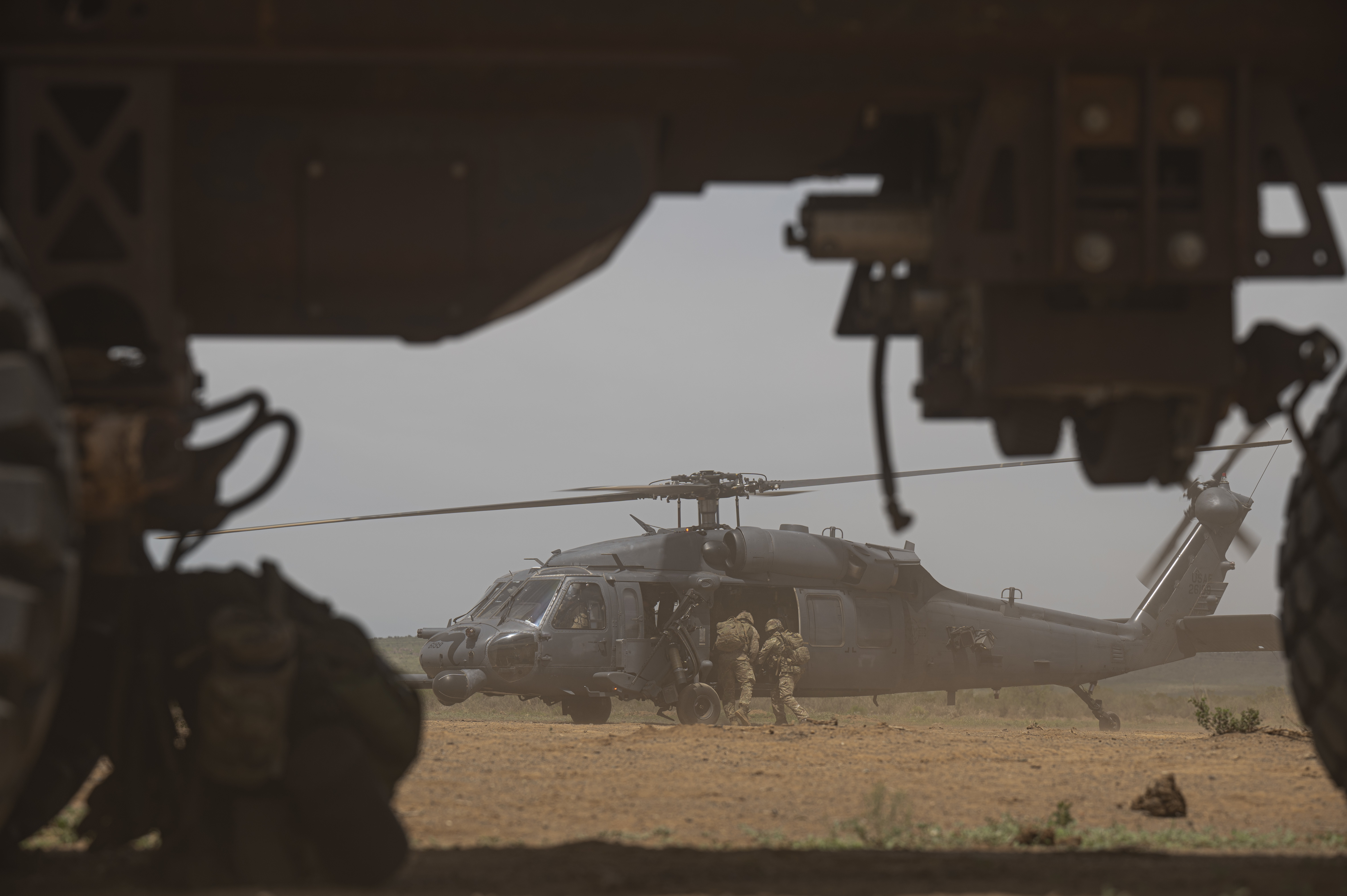Image shows RAF Regiment boarding helicopter in the desert.